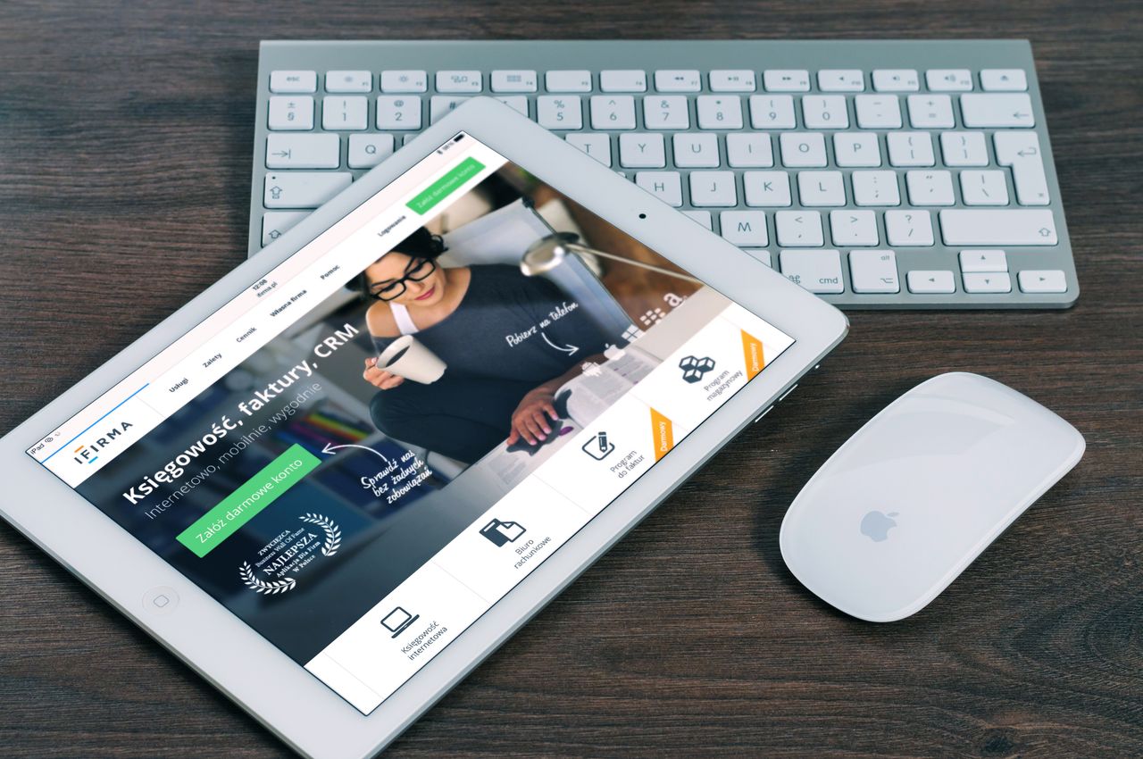 services-02 A tablet with a financial website open, alongside a white keyboard and mouse. Ideal for tech-theme stock images.